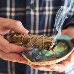 Ritual de purificação energética com incenso e cristais numa casa